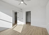 Thumbnail 17 of 51 - A room with a ceiling fan and two doors at Brickside Heights, Millcreek, 84106