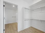 Thumbnail 42 of 51 - A white closet with a door and shelves at Brickside Heights, Millcreek, Utah