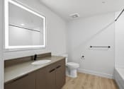 Thumbnail 40 of 51 - A white bathroom with a sink, toilet, and mirror at Brickside Heights, Millcreek