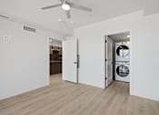 Thumbnail 28 of 51 - A room with a ceiling fan and a washing machine in the doorway at Brickside Heights, Millcreek