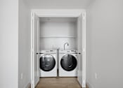 Thumbnail 36 of 51 - A laundry room with two washing machines at Brickside Heights, Millcreek, Utah