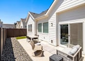 Thumbnail 10 of 20 - A white house with a patio furniture set. at Alante Homes at Spring Run, Caldwell, Idaho
