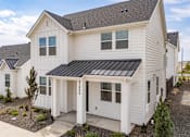Thumbnail 2 of 20 - A white house with a black roof and a small tree in front. at Alante Homes at Spring Run, Caldwell, ID