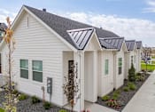 Thumbnail 4 of 20 - A white house with a grey roof and a grey gutter. at Alante Homes at Spring Run, Caldwell, ID, 83607