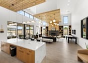Thumbnail 14 of 32 - A modern kitchen with a large island and wooden ceiling at Alante Homes at Spring Run, Caldwell, ID