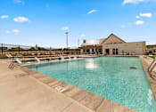 Thumbnail 7 of 32 - A large outdoor swimming pool with a building in the background at Alante Homes at Spring Run, Caldwell, ID, 83607