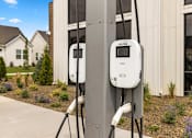 Thumbnail 12 of 32 - Two electric vehicle charging stations are installed on a pole outside a house. at Alante Homes at Spring Run, Caldwell, Idaho