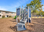 Thumbnail 9 of 9 - A playground with a slide and monkey bars.