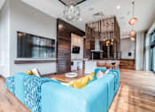 Thumbnail 2 of 8 - Indoor lounge area with TV, display kitchen, bar seating, theater seating and connected to outdoor pool at CityWay Apartments, Indianapolis, IN, 46204
