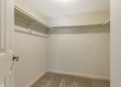 Thumbnail 7 of 13 - a walk in closet at the whispering winds apartments in pearland, tx at Copper and Quarry Village, Pikesville, MD, 21209