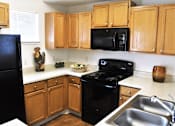 Thumbnail 8 of 24 - Full Kitchen with Microwave and Dishwasher at Apts in Denver Colorado