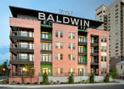Thumbnail 2 of 31 - Exterior view of a modern apartment building with balconies, large windows, and street-facing landscaping