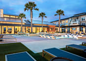 Thumbnail 2 of 25 - Upscale pool deck offering in-water relaxation areas, ample lounge seating, and a sophisticated resort atmosphere.