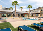 Thumbnail 3 of 25 - Inviting outdoor amenity area with a sparkling pool, resort-inspired landscaping, and plenty of room to enjoy the sunshine.