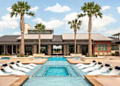 Thumbnail 5 of 25 - Beautiful swimming pool surrounded by palm trees, elegant landscaping, and thoughtfully designed gathering areas.