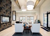 Thumbnail 25 of 25 - Upscale resident clubhouse featuring stylish lounge seating, vaulted ceilings, and abundant natural light throughout.