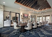 Thumbnail 21 of 25 - Sophisticated resident clubhouse featuring a large conference table, modern fireplace, and designer finishes throughout.