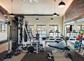 Thumbnail 23 of 25 - State-of-the-art fitness center featuring strength training equipment, cardio machines, and dedicated workout space.