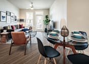 Thumbnail 12 of 25 - Bright open-concept living and dining area with contemporary furnishings, large windows, and access to a private balcony.