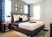 Thumbnail 13 of 25 - Spacious bedroom featuring large windows, plush carpeting, and contemporary finishes for a comfortable retreat.
