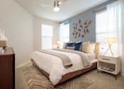 Thumbnail 14 of 25 - Spacious bedroom featuring large windows, plush carpeting, and contemporary finishes for a comfortable retreat.