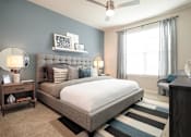 Thumbnail 15 of 25 - Spacious bedroom featuring large windows, plush carpeting, and contemporary finishes for a comfortable retreat.