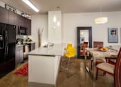 Thumbnail 5 of 28 - Open Concept Kitchen with Island/ Breakfast Bar at Apartments for Rent Oak Lawn Dallas
