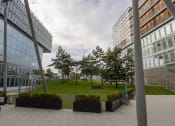Thumbnail 4 of 5 - a park in the middle of some tall buildings