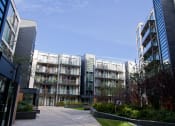 Thumbnail 3 of 5 - a group of apartment buildings with a pathway between them
