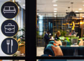 Thumbnail 4 of 19 - a window view of a restaurant with people sitting at a table