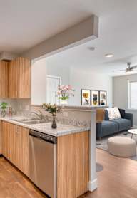 A white refrigerator is open in a kitchen.