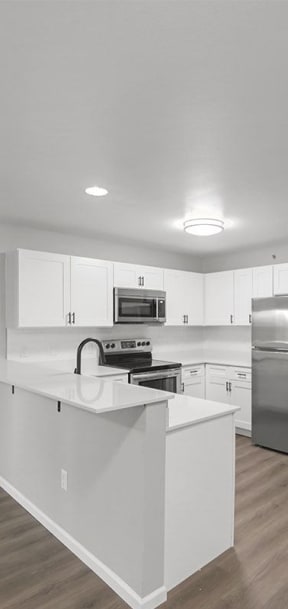 a kitchen with an island and stainless steel appliances