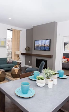 A modern living room with a fireplace and a television.