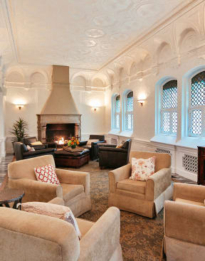 a living room with couches and chairs and a television at Residences at Forest Park, Saint Louis, MO