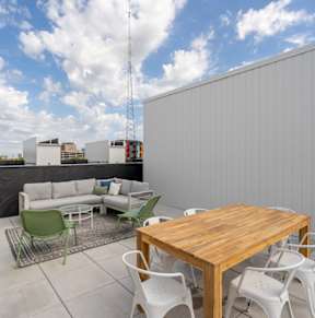 a patio with a table and chairs and a sky ceiling at Matilda 235 Townhomes, Des Moines, 50309