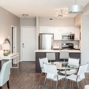 a kitchen and living room with a table and a tv