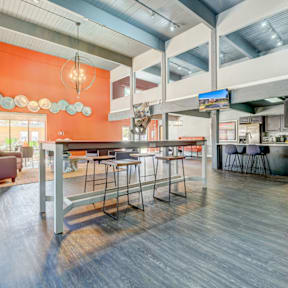A modern open space with a bar and seating area.