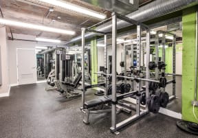 a gym with weights and other exercise equipment in a building at Residences at Forest Park, Saint Louis, Missouri