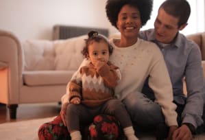 a family sitting on the floor in a living room