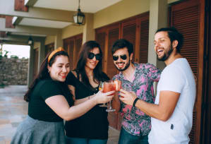 a group of people holding drinks and posing for a picture