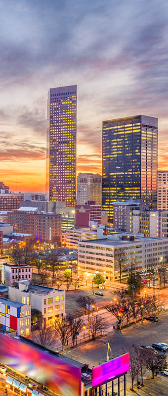 a view of the houston skyline at sunset with a ferris wheel in the foreground