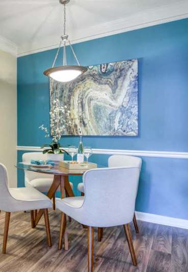 A kitchen with a table and chairs.