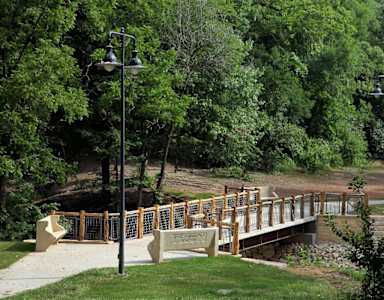 A bridge with a railing and lamp posts on either side.