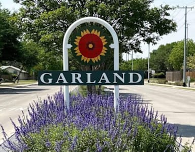 A sign that says Garland with a sunflower on it.