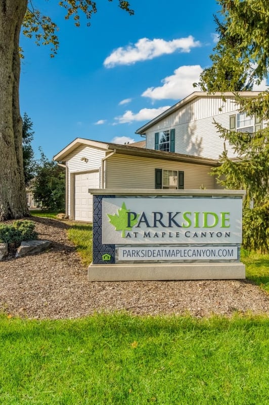 a parkide sign in front of a house with trees at Parkside at Maple Canyon Apartments, Columbus, OH 43229