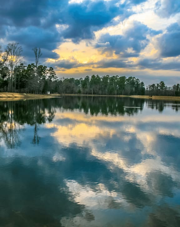 A serene lake with a sunset in the background.