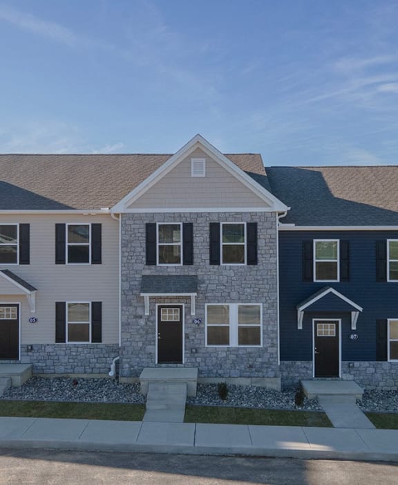 a row of three story houses on a street