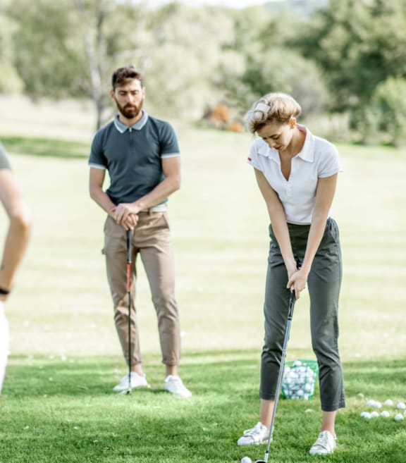 a group of people standing on the grass in a park