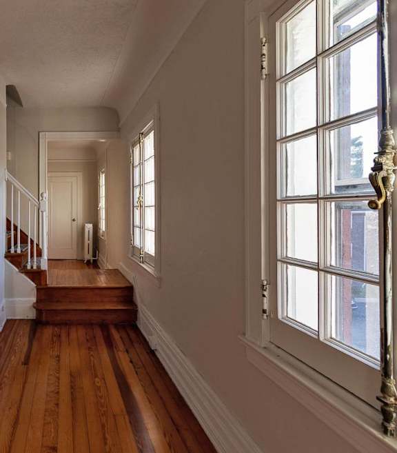 an empty house with wooden floors and a staircase