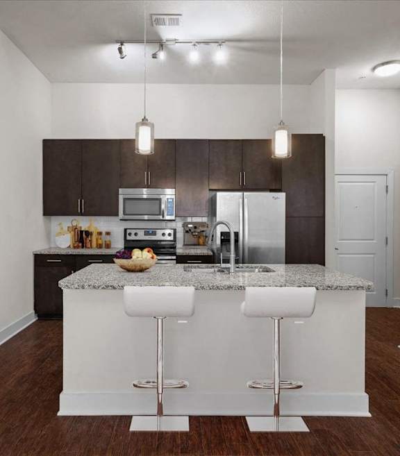 a white kitchen with stainless steel appliances and a sink